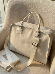 Cream PU leather travel bag with adjustable strap and top handles, perfect for toiletries.
