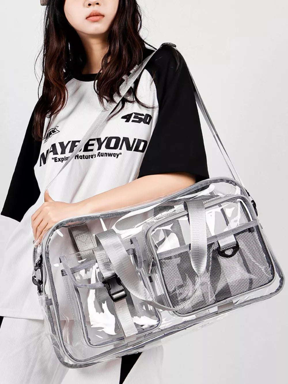Sleek transparent travel duffel bag with grey accents and multiple pockets.