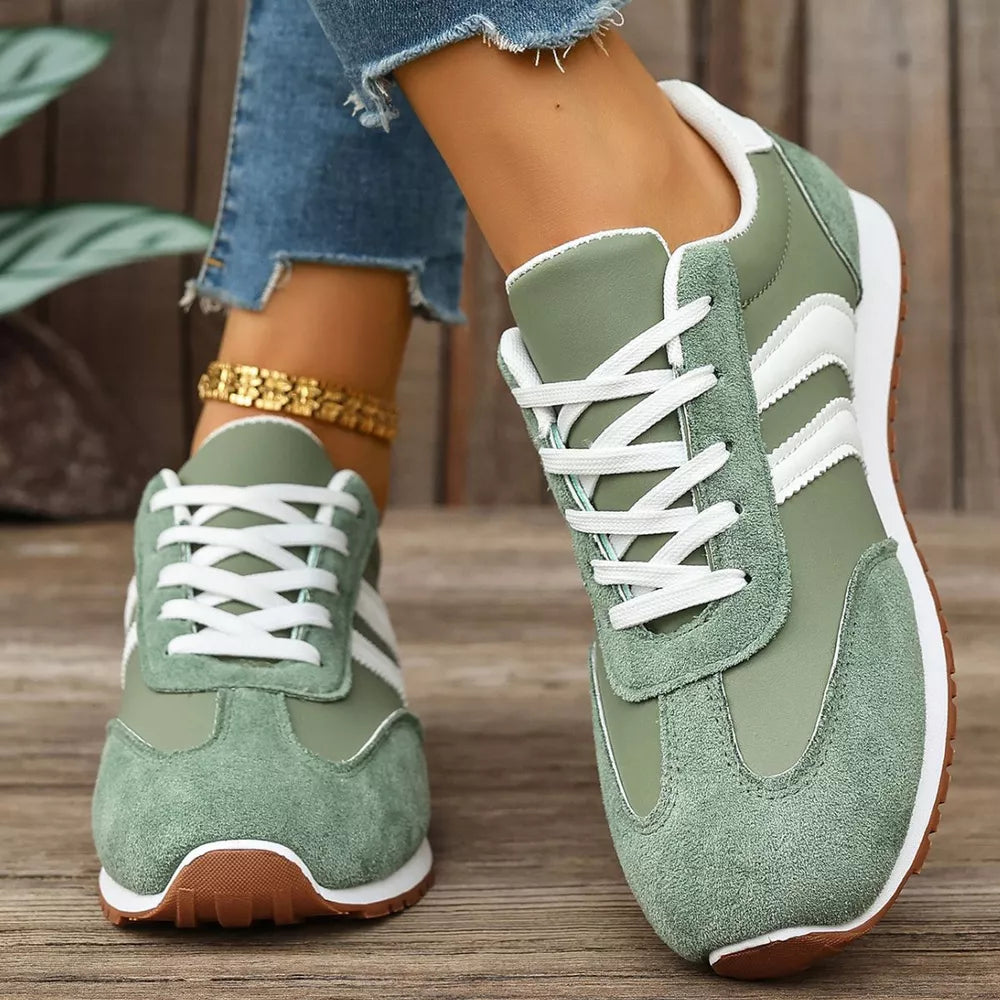 Green suede lace-up sneakers with white stripes and laces.