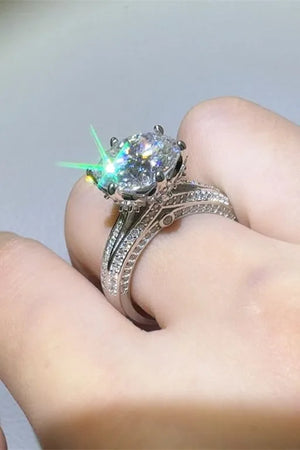 Silver moissanite ring with a large oval center stone and pavé band.