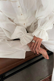 White gauze lounge set with voluminous ruffled sleeves and button front detail
