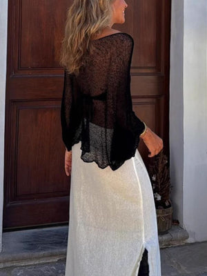 Black textured knit batwing cover-up with sheer acrylic fabric and a scalloped hem.