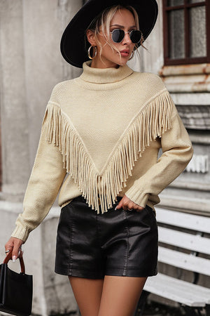 Beige turtleneck sweater with chevron fringe detail and long sleeves