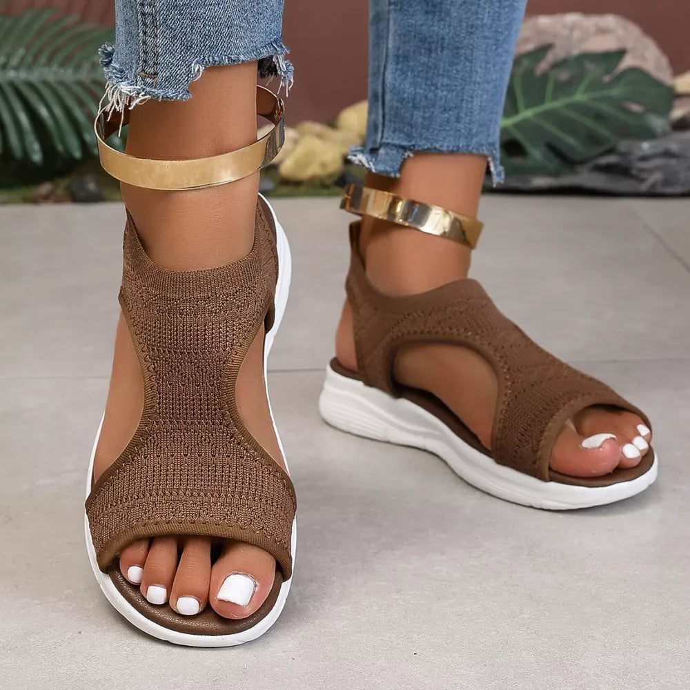 Brown knit open-toe platform sandals with white soles and gold ankle straps.