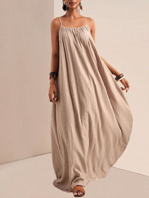 Khaki maxi dress with spaghetti straps and a gathered neckline, flowing A-line skirt.