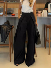 Black wide-leg pants with a high waist and pleats, styled with a white top.