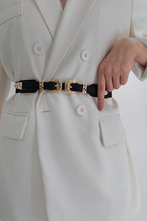 Black elastic waist belt with double gold western buckles and ornate detailing.