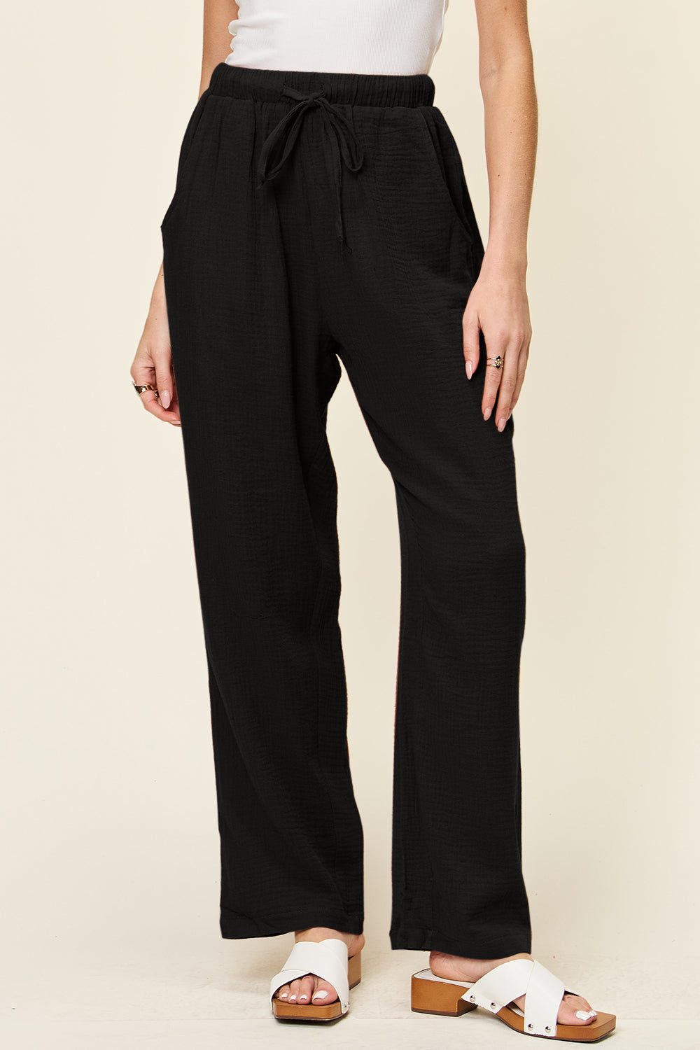 Black textured gauze relaxed drawstring trousers with pockets