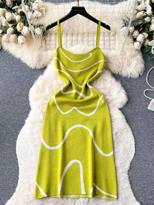 Green wavy knit midi dress with spaghetti straps and white abstract pattern.