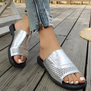 Chic silver slide sandals with hollow-out detail and breathable mesh accents.