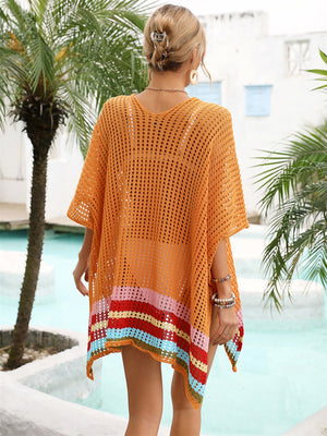 Orange crochet beach cover-up with rainbow stripe hem detail, V-neck, and short sleeves.