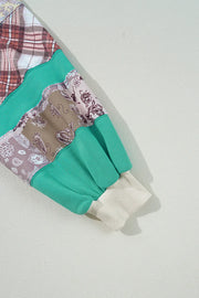 Patchwork raglan sleeve sweatshirt in turquoise with plaid and paisley patterns, ribbed cuff.