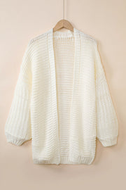 Textured knit cocoon cardigan in off-white with balloon sleeves and open front.