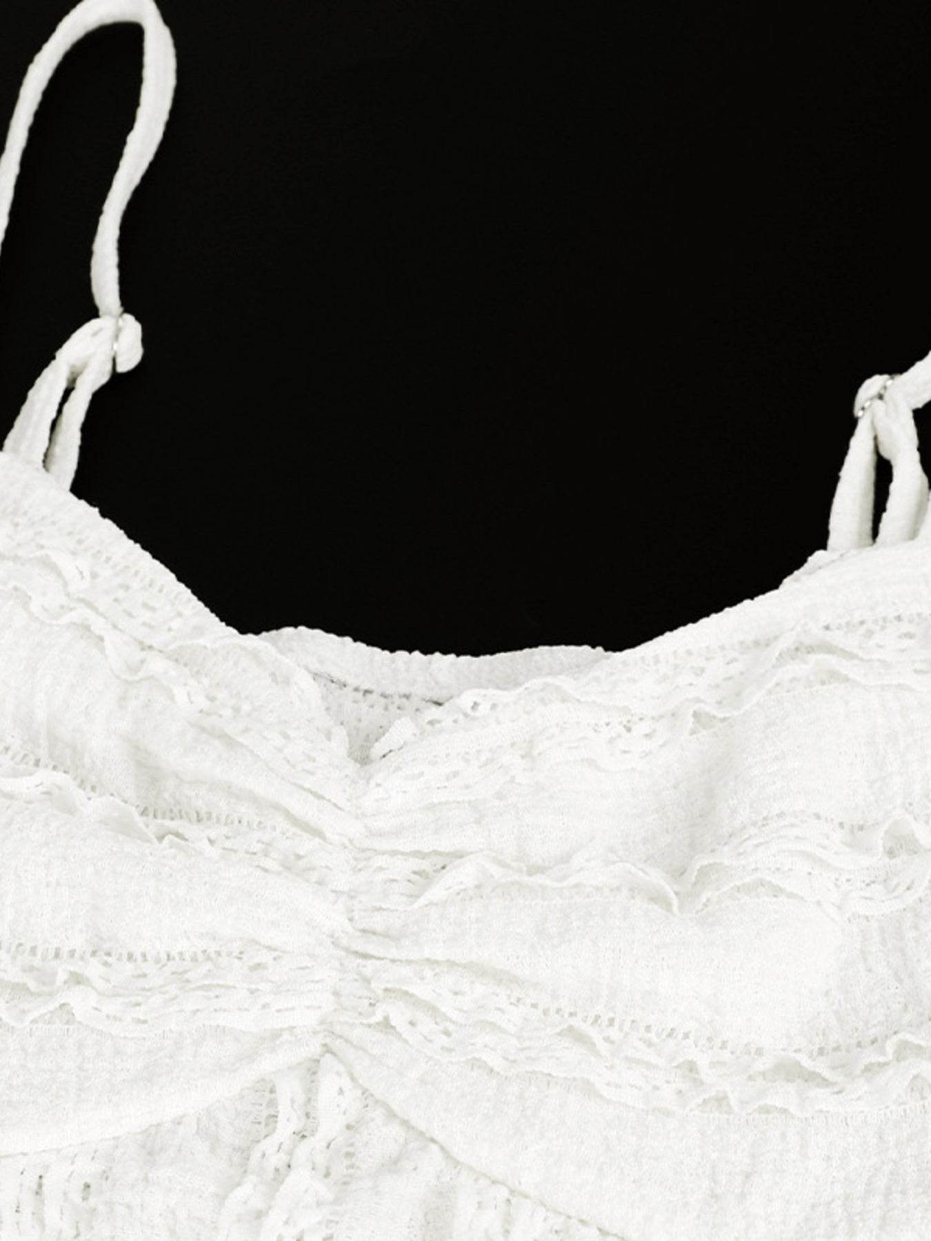 White sweetheart neck cami top with textured fabric and ruffled details.