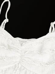 White sweetheart neck cami top with textured fabric and ruffled details.