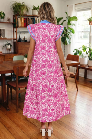 Vibrant floral midi dress with ruffle sleeves and blue trim.