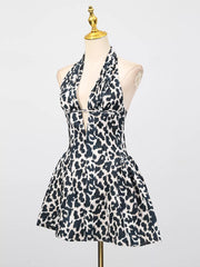 Leopard print halter neck mini dress with a deep V-neck and flared skirt.