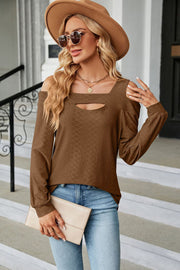 Brown textured open shoulder blouse with keyhole neckline and long sleeves.