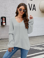 Light grey ribbed knit sweater with V-neck and lace-up detail