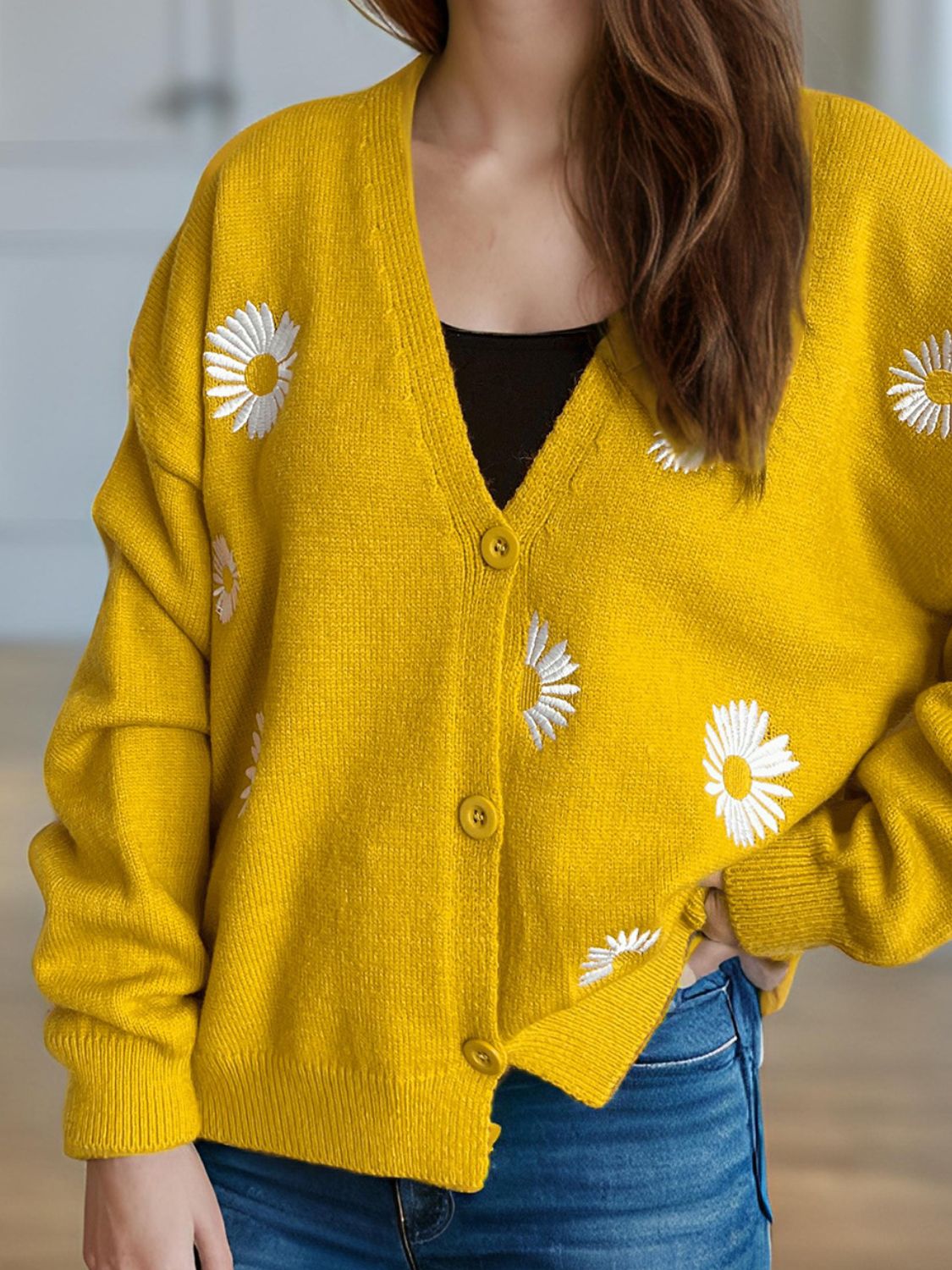Yellow oversized knit cardigan with daisy embroidery, V-neck, button front, and long sleeves.