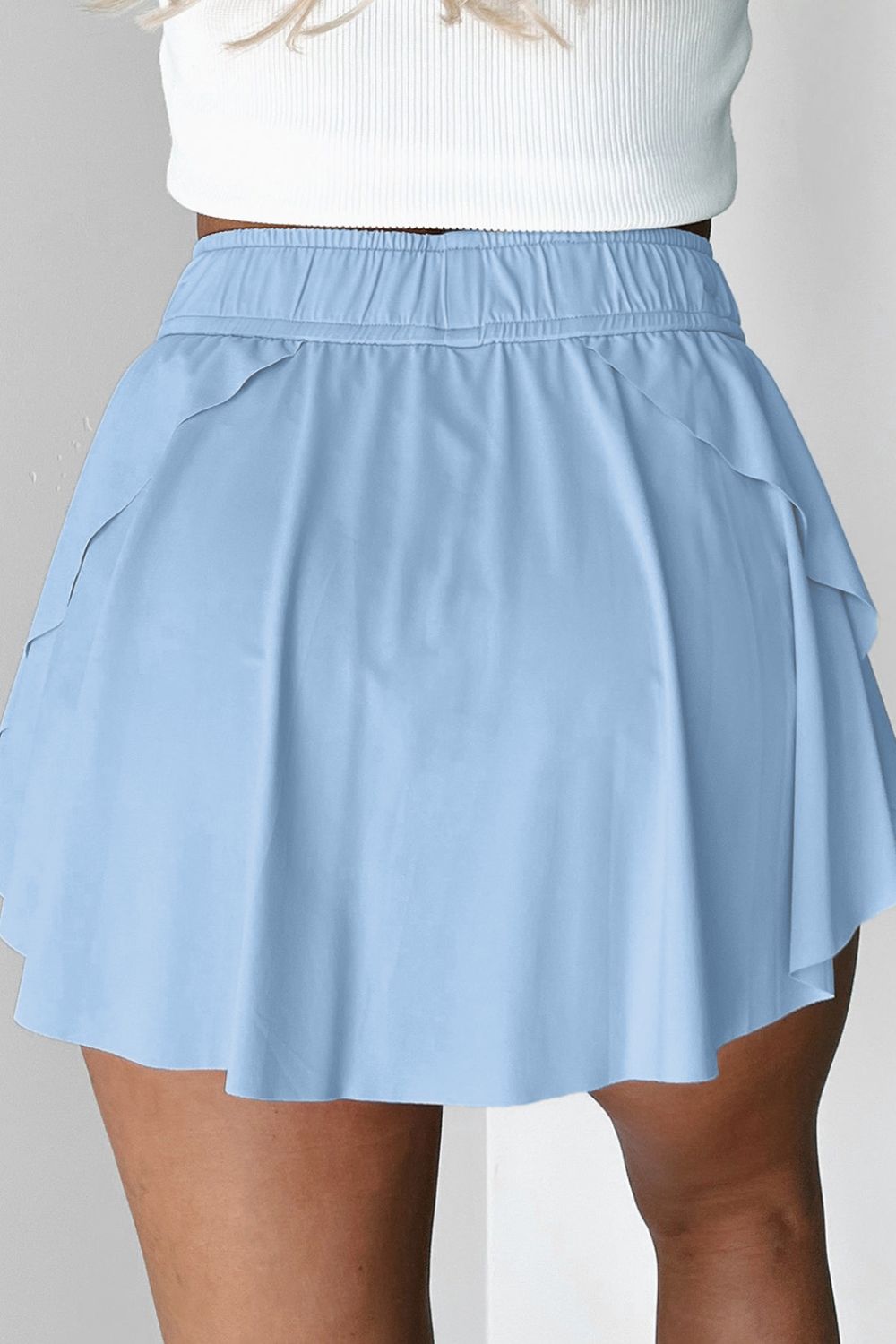 Light blue ruffled skort with tie waist detail and elastic waistband.