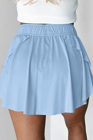 Light blue ruffled skort with tie waist detail and elastic waistband.