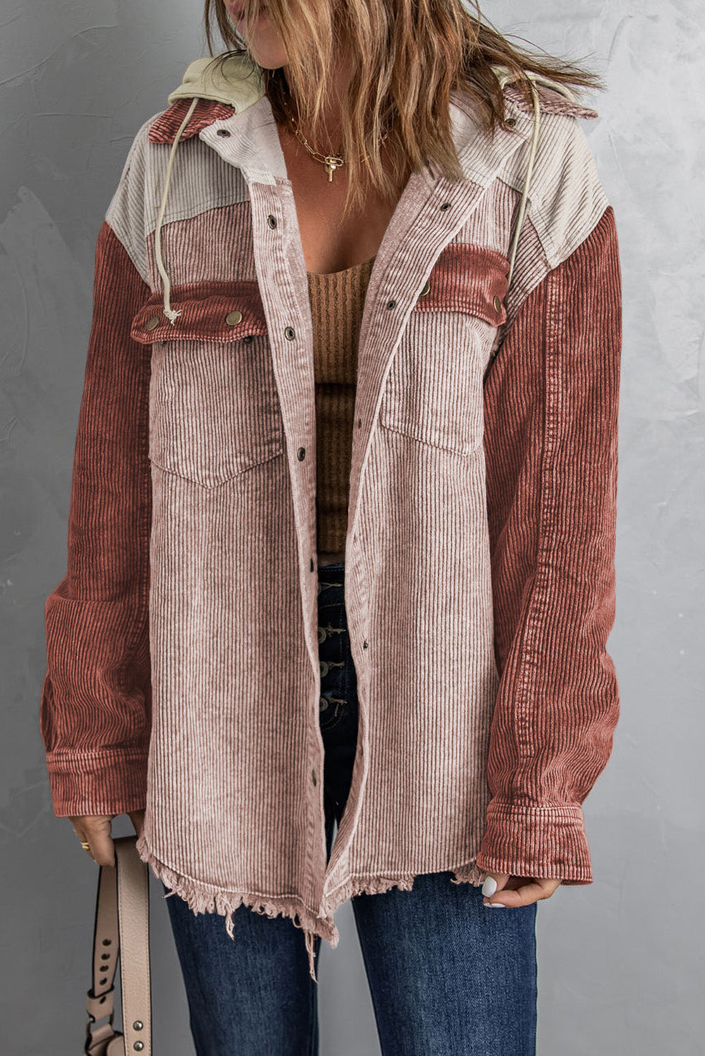 Colorblock corduroy hooded utility jacket with frayed hem and contrast sleeves.
