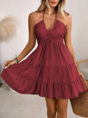 Burgundy ruched halter tiered mini dress with ruffles and a V-neck.