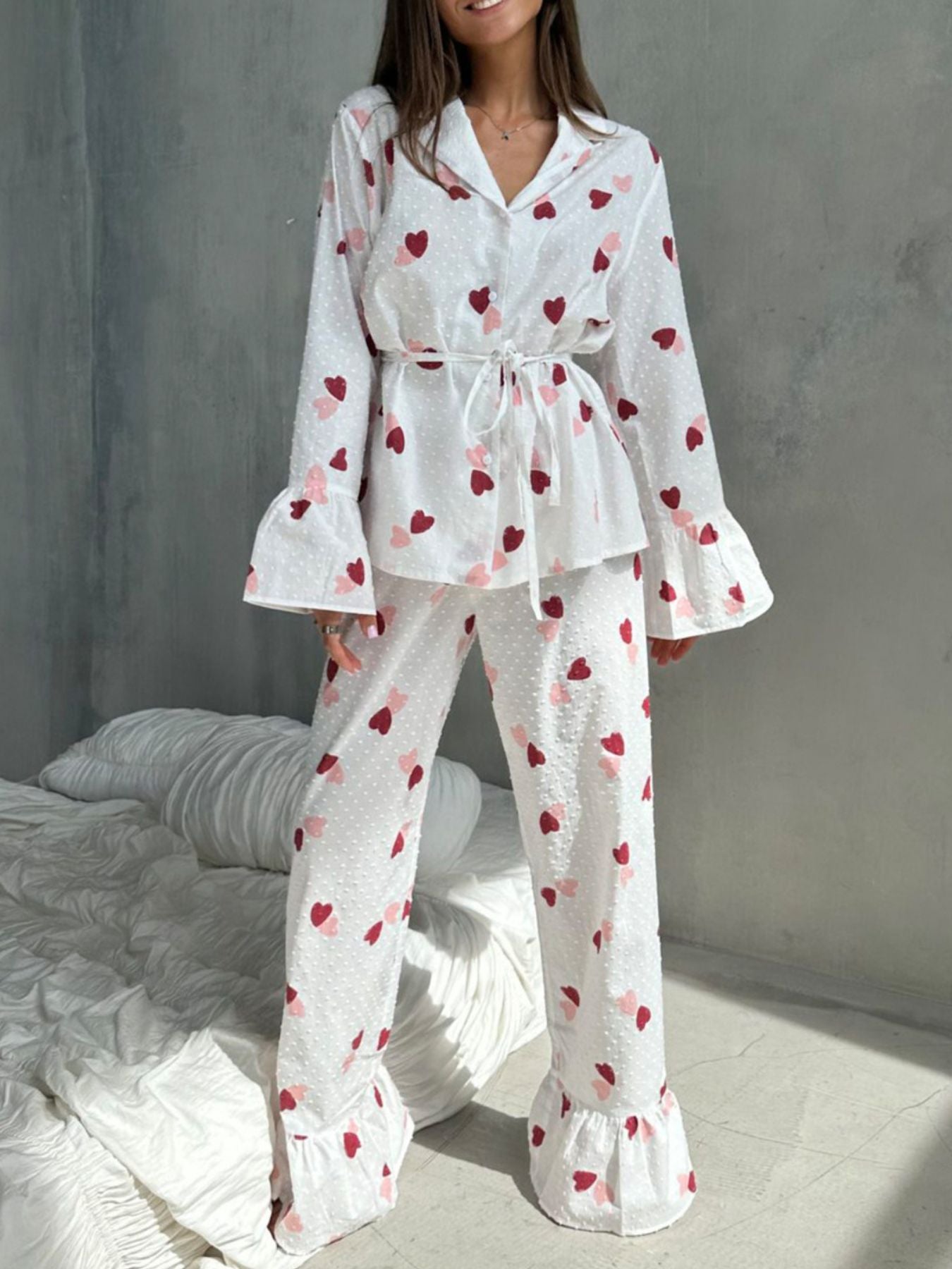 White cotton button-down pajama set with red and pink hearts and ruffled cuffs.