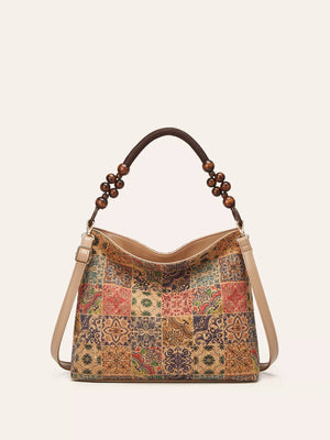 Vibrant bohemian hobo tote with geometric tile pattern and beaded strap detail.