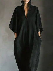 Black maxi dress with deep V-neck, wide sleeves, and pockets
