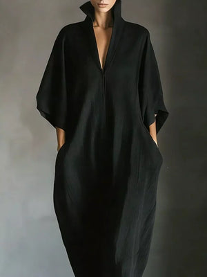 Black maxi dress with deep V-neck, wide sleeves, and pockets