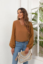 Camel V-neck blouse with sheer pom-pom balloon sleeves and elastic cuffs.