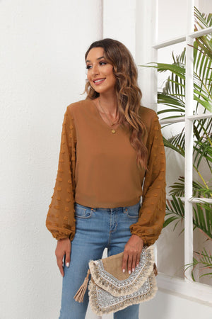 Camel V-neck blouse with sheer pom-pom balloon sleeves and elastic cuffs.