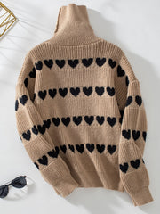 Taupe turtleneck sweater with black heart intarsia pattern and ribbed cuffs.