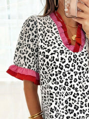 Ruffled leopard print blouse with pink and red trim on sleeves and neckline.