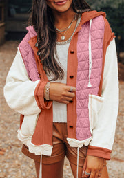 Colorblock quilted hooded waffle jacket in dusty pink with white waffle sleeves and orange accents.