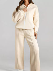 Beige cotton zip-up jacket and drawstring pants set with white zipper detail and seam accents.