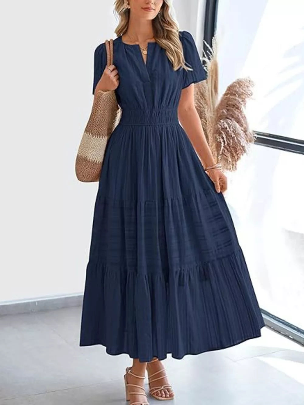 Dark blue ruched V-neck tiered midi dress with short sleeves and smocked waist.