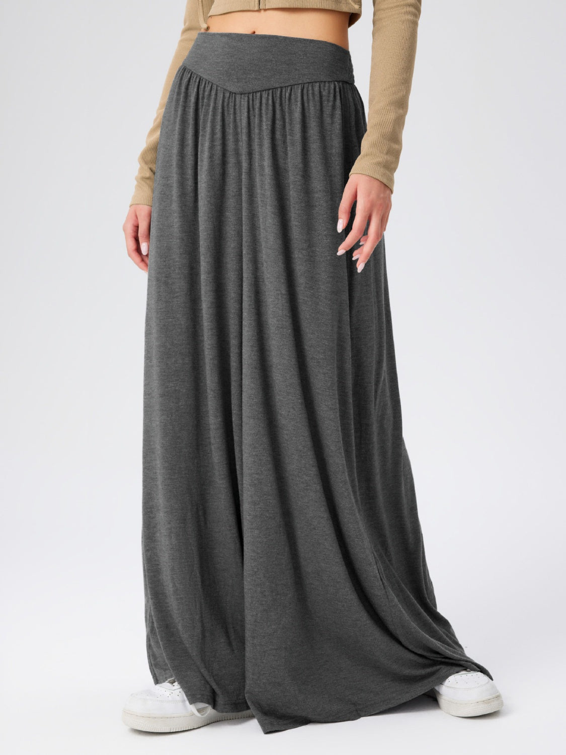 Dark gray jersey wide-leg trousers with a drape-front waistband.