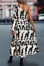 Geometric print asymmetric maxi dress with belt in black and white.