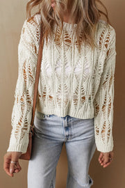 Ivory open-knit crochet crop sweater with distressed details and a relaxed fit.