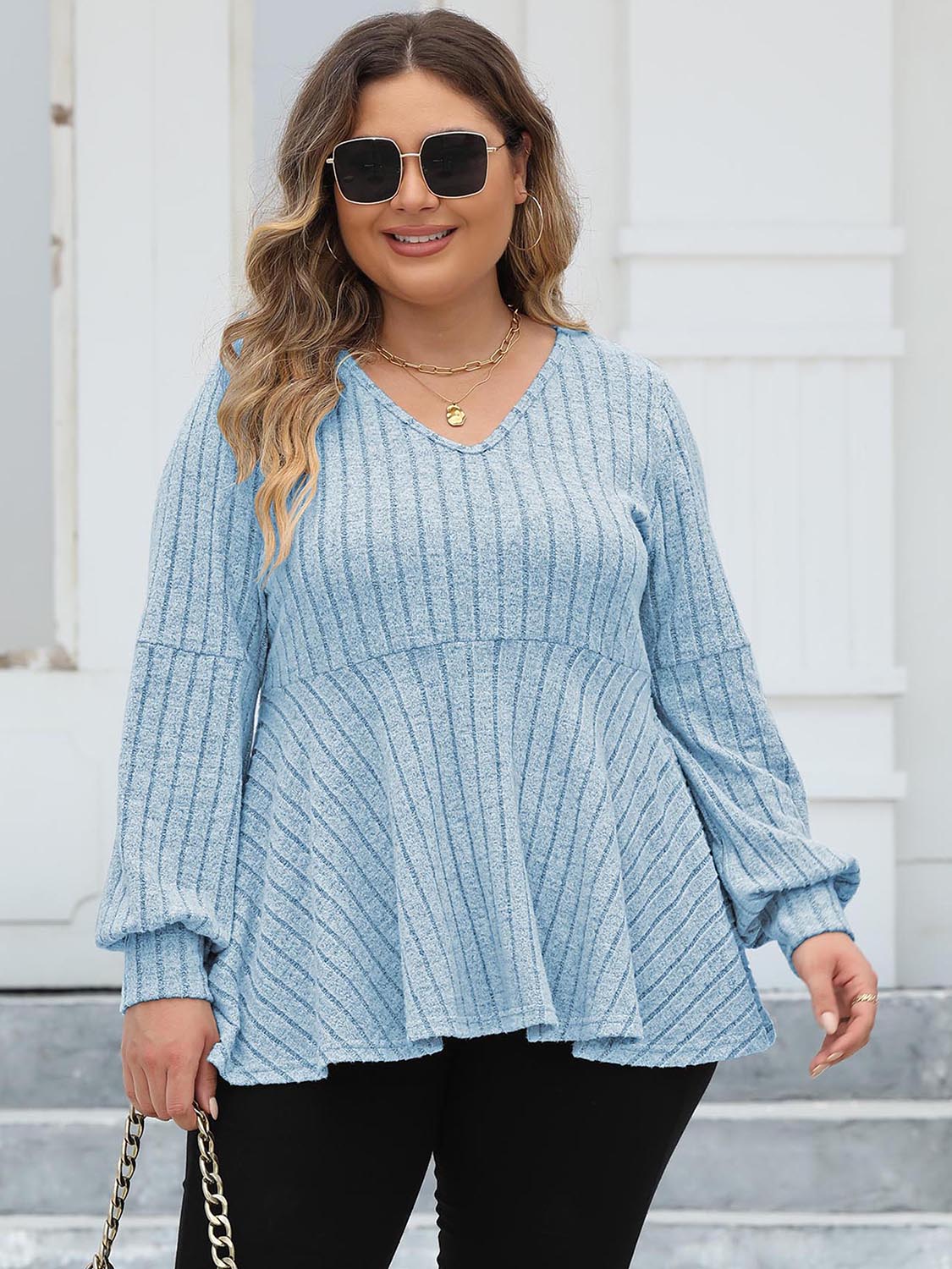 Pastel Blue ribbed peplum knit top with blouson sleeves and V-neck.