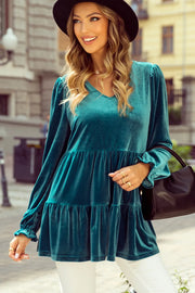 Turquoise velvet tiered blouse with puffed sleeves and v-neck.