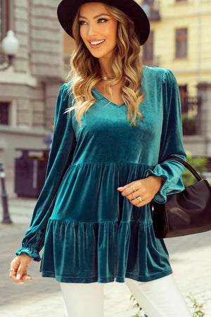 Turquoise velvet tiered blouse with puffed sleeves and v-neck.