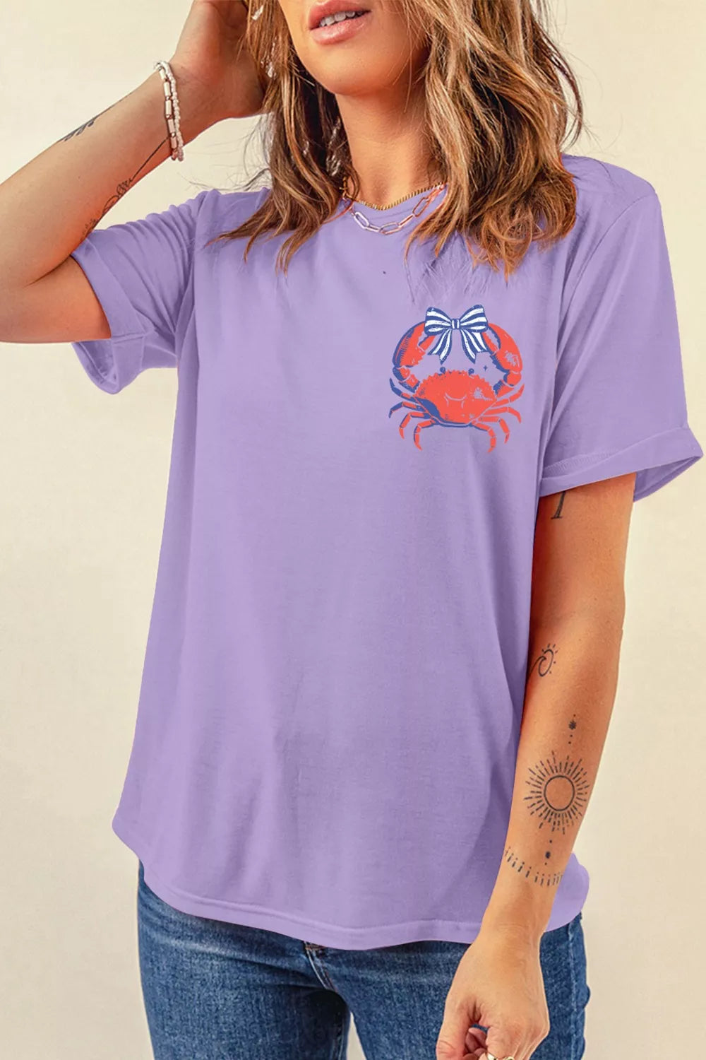 Lavender maternity t-shirt with a playful red crab graphic and blue striped bow on the chest.