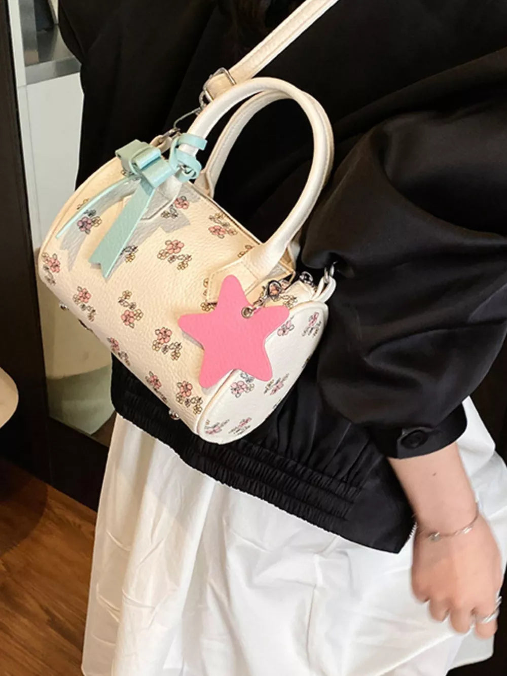 Charming floral mini crossbody bag with pink star charm and blue bow detail