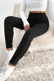 Black textured knit leggings with a high waist and ribbed detail.