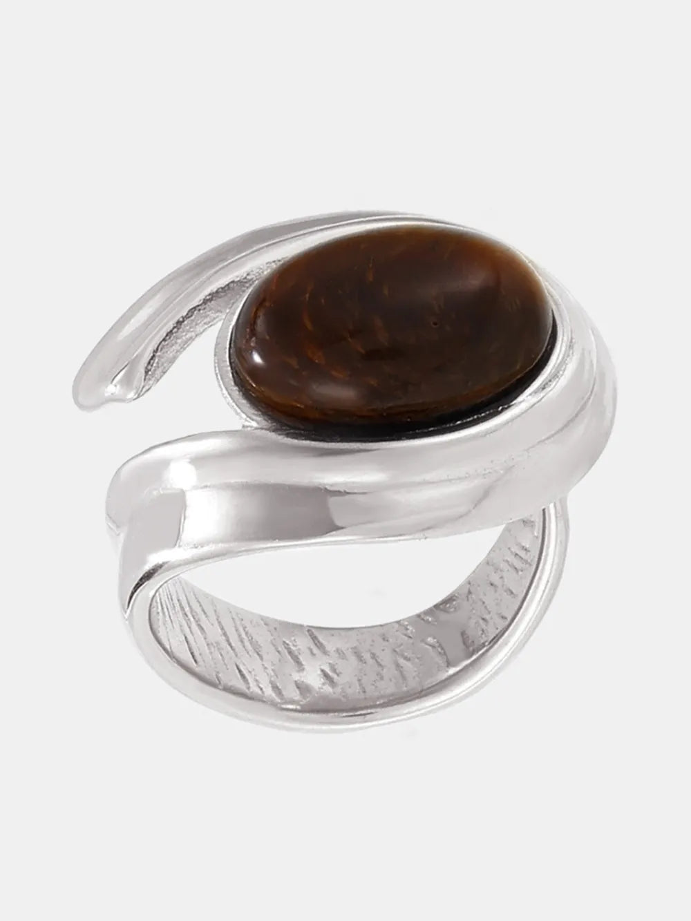 Silver ring with a sculptural swirl design and a brown tiger's eye stone.