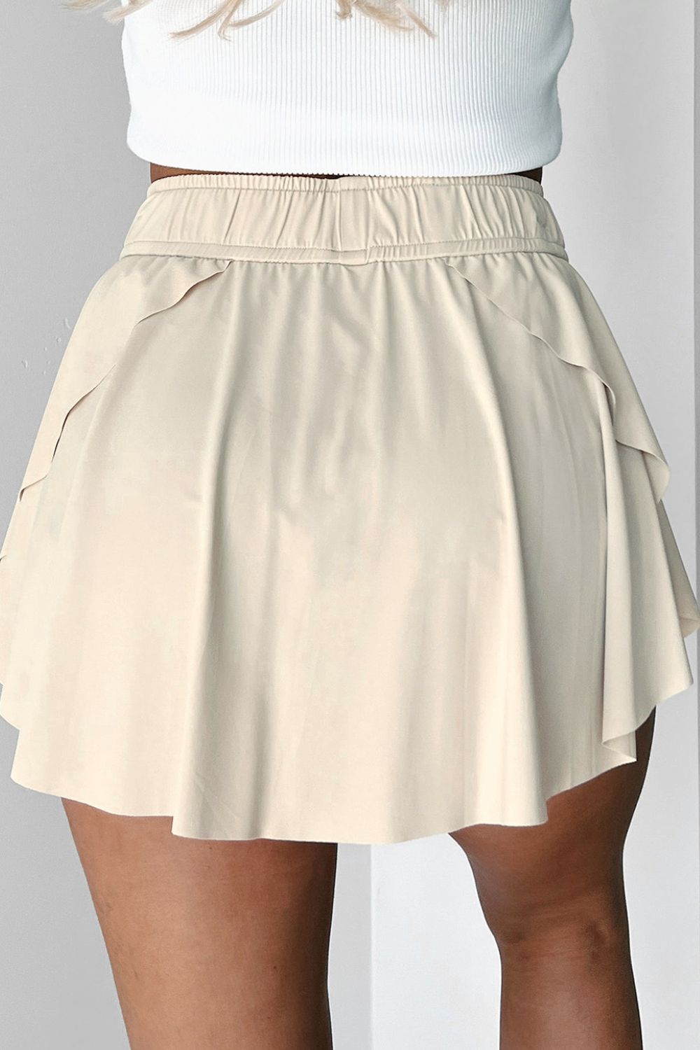 Beige ruffled skort with elastic waistband and tie detail